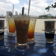 Cà phê sữa đá (iced coffees with milk), sinh tố (fruit shake), and a cool river breeze at Cafe A & B